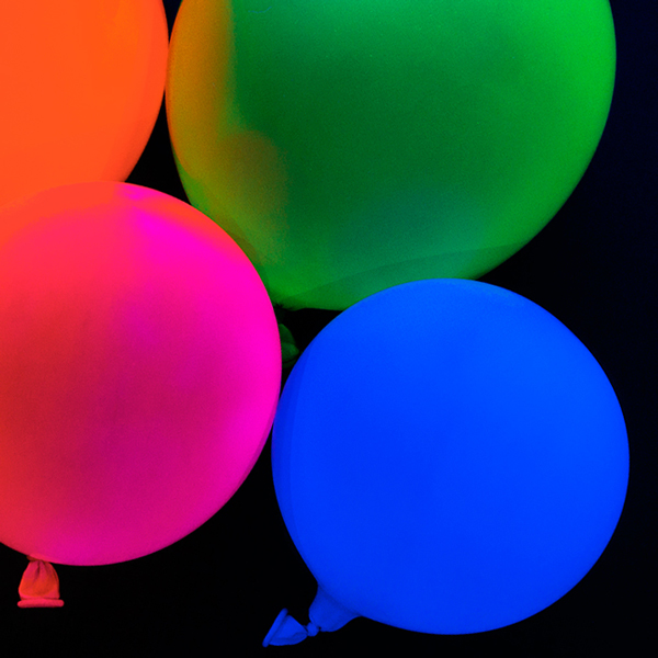 Ballons glowing under Sunlite Led True Blacklight Blue UV-A A19 Light